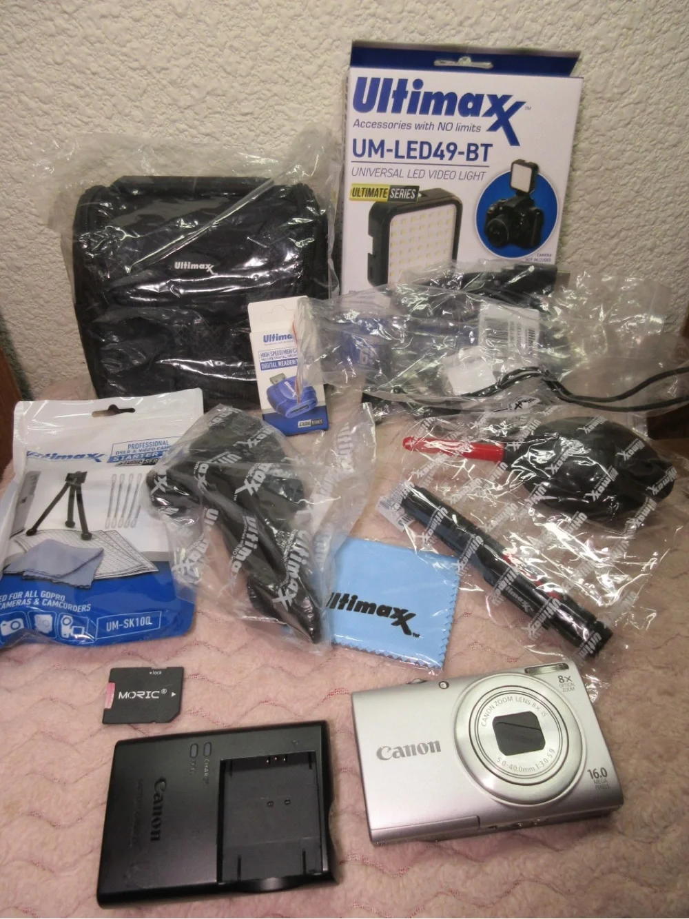 Canon Silver Compact Camera with Black Charger and Accessories